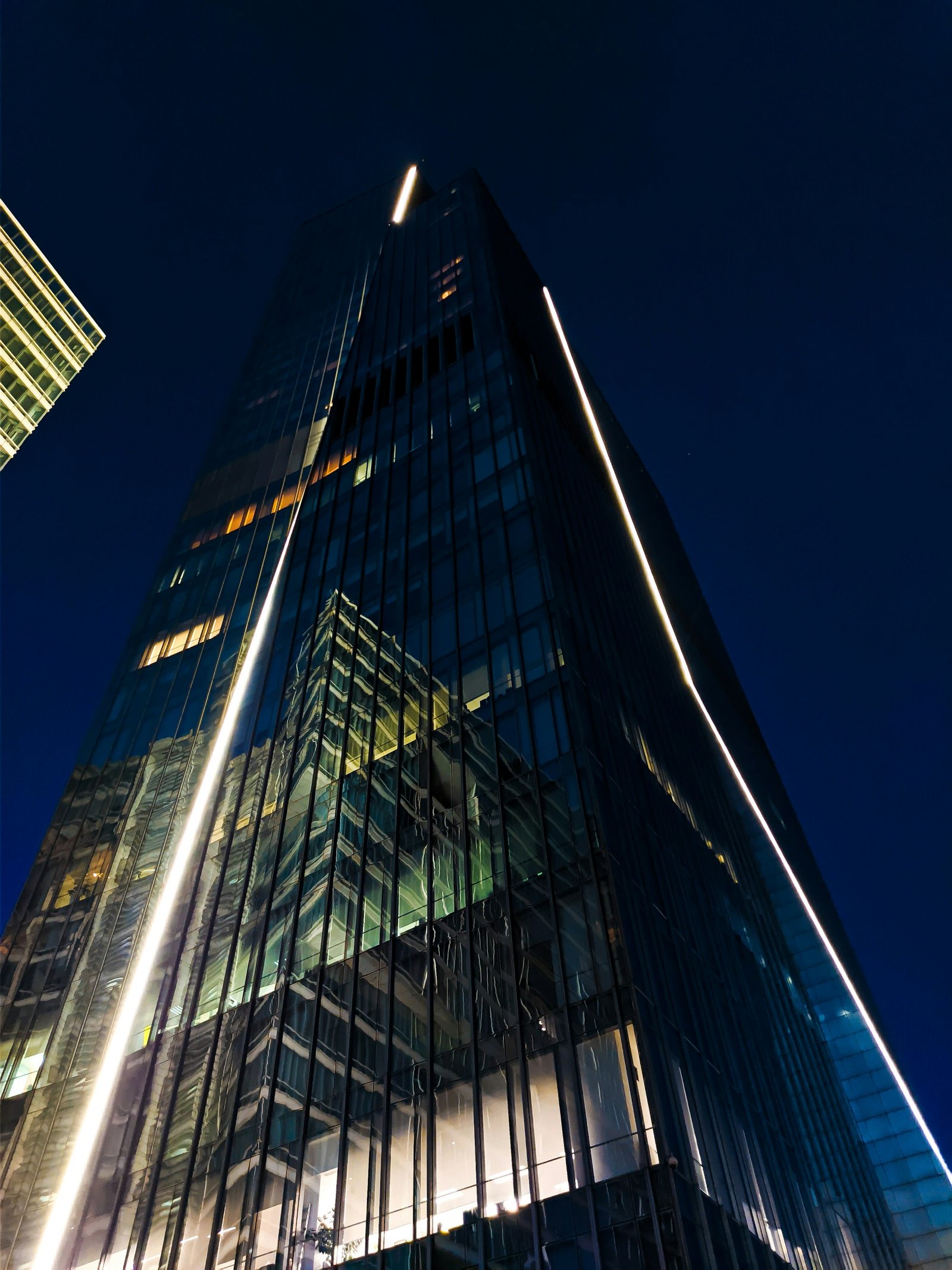 Illuminated glass skyscrapers viewed from below